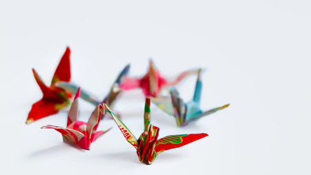 Cluster of traditional Japanese origami paper cranes on a clean white background. Minimalist design symbolizing peace, focus, and hope. Great for wellness content.の写真素材