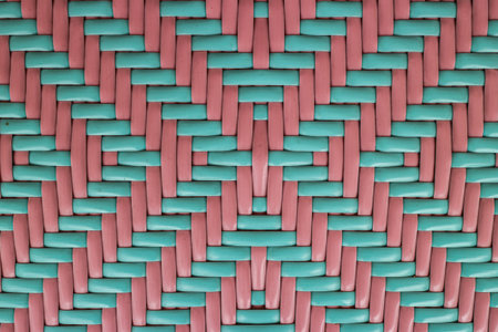 Vibrant abstract background of woven plastic in soft pastel mint green and pink. Geometric texture suitable for modern Asian craft, backdrop, or design.の写真素材