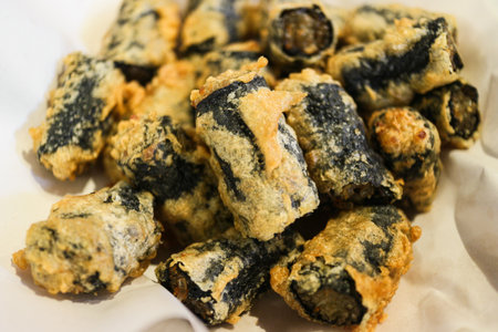 Crispy Gimmari (Korean deep-fried seaweed rolls) stacked. Popular K-Food street snack, savory appetizer, and Asian fast food concept.の写真素材