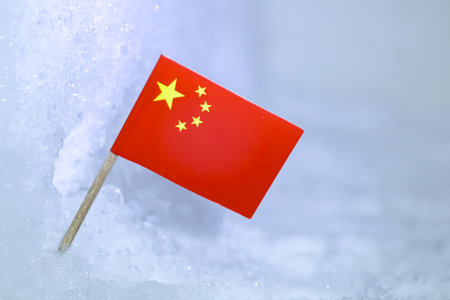 Close-up of the Chinese flag on textured glacial snow.