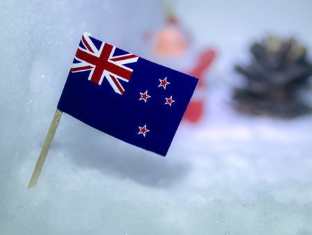 Close-up of the flag on textured glacial snow. Subtle blurred holiday elements suggest Christmas/New Year travel and adventure.の写真素材