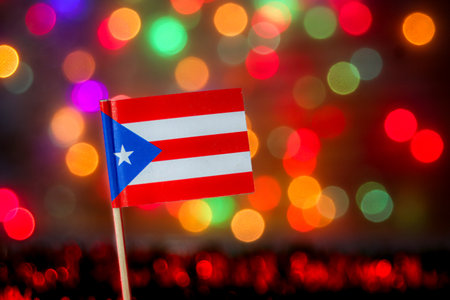 The Puerto Rican national flag with its iconic colors. The festive bokeh background of colorful lights is perfect for celebrations, Caribbean pride, and major national events.の写真素材