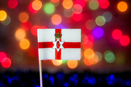 The flag with its symbolic red hand. The festive bokeh background of colorful lights is perfect for celebrations, pride, major national events.の写真素材
