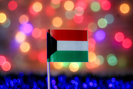 The national flag with its bold colors. The festive bokeh background of colorful lights is perfect for celebrations, Gulf region business, and major national events.の写真素材