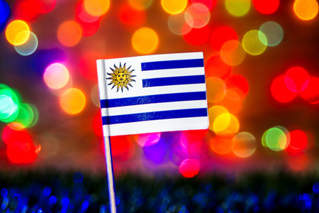 Uruguay flag with soft colorful bokeh lights symbolizing independence and South American pride. Ideal for travel, editorial, and festive design use.の写真素材
