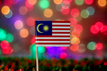 Malaysian flag with colorful festive bokeh background. Perfect for themes of freedom, unity, celebration, and ASEAN cultural pride.の写真素材