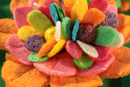 Rainbow lotus flower krathong crafted from biodegradable corn puffs. Eco-friendly DIY for Loi Krathong Day, emphasizing vibrant color and sustainability trends.の写真素材