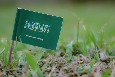 Saudi Arabia national flag on green grass symbolizing desert greening, sustainability, climate...