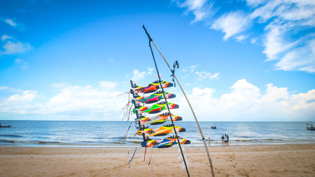 Colorful airplane kites on a sandy beach with a cerulean sky and blue sea, symbolizing summer travel, coastal lifestyle, outdoor leisure, and seaside festival themes.の写真素材