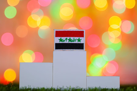 Iraq flag on a first place podium against colorful bokeh, symbolizing national achievement, global success, victory, excellence and winning ambition.