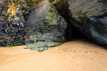 Cave on the coast, Welcome on the sandの写真素材