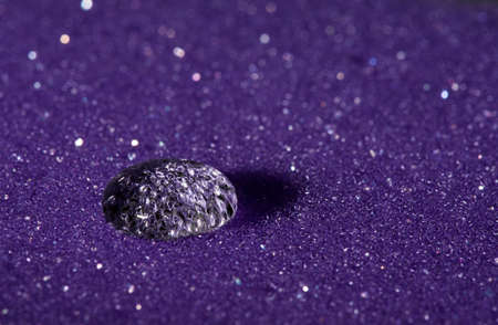 Water drop on purple sponge with glitter.の写真素材