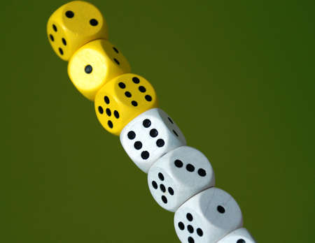 A tower with white and yellow dice over a green background