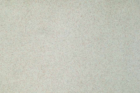 The texture of the gray surface of the stone with small white black and brown inclusions.の写真素材