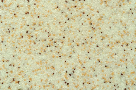 Texture of beige ceramic coating with dark inclusions, macro.の写真素材
