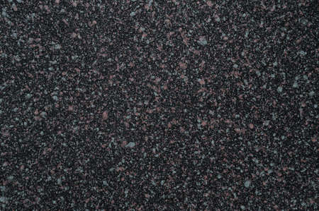 The texture of the artificial ceramic coating is black with colored inclusions.の写真素材