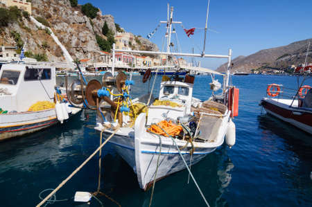 Fishing boat at the pier in the Bay of the island of Simi.の写真素材