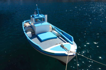 Fishing boat on a rope at the pier, Simi island, Greece.の写真素材