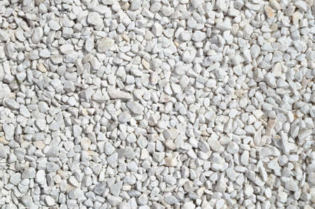 Light gray gravel on the path, light crushed stone texture, background.の写真素材