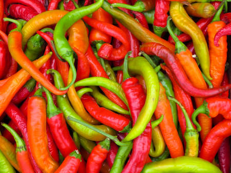 Red and green hot peppers on the market.