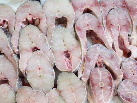 Fresh sea fish steaks on the counter, background.