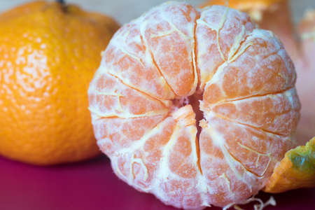 Fresh peeled tangerine, mandarin fruits.