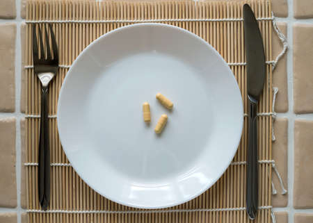 Tablet capsule for lunch on a white plate.