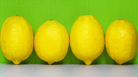 Four fresh lemons on the kitchen table.