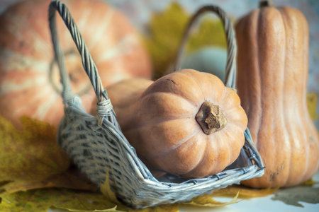 Orange pumpkin in a wicker basket.