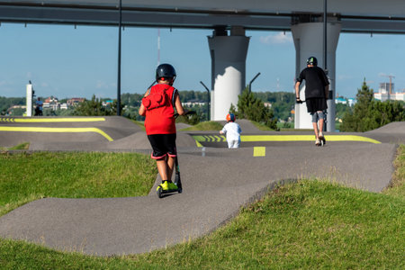 Riding a scooter in the park.の写真素材