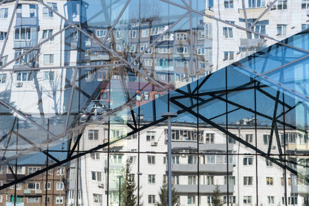 Reflection of the houses opposite in the glass facade of the building.の写真素材