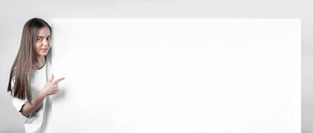 Attractive youth in a young model showing a snow-white sheet of paper.の写真素材