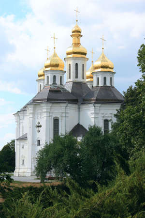  Ancient church with gold domes against the bright sky