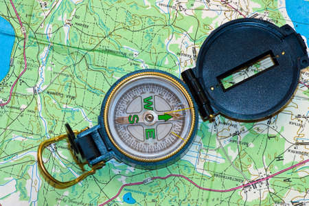 The compass lays on a green map
