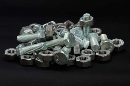a big heap of bolts and nuts,  macro, black background