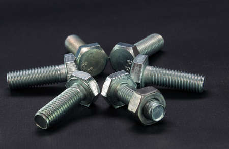 bolts and nut steel macro, black backgroundの写真素材