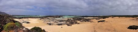 Panoramic view over sandy beach of volcanic island Lanzarote