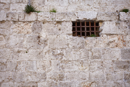 Window of an ancient dungeon with stone wall