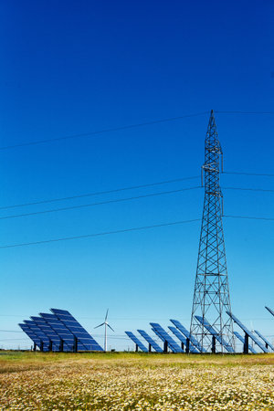 Landscape with wind turbines, solar panels and electrical towersの写真素材