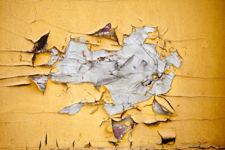 Cracked Yellow Paint detail for grunge Background or Textureの写真素材