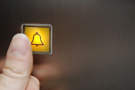Pushing the illuminated panic button in an elevator.の写真素材