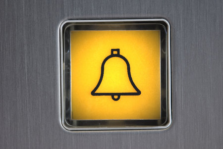Panic button - macro detail of a luminescent panic button in an elevator.の写真素材