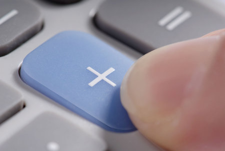 Macro detail: pushing the blue plus button on a calculator.の写真素材