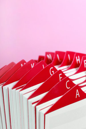 Close up of a red Business Card Holder in front of pink background.の写真素材