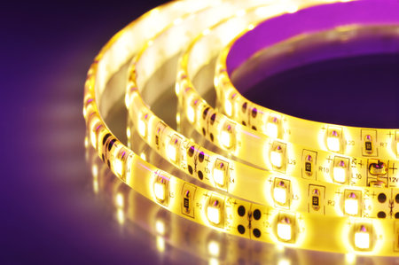 macro detail of a warmwhite LED-stripe in colored spotlightの写真素材
