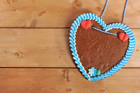 unlabeled original bavarian gingerbread heart from Germany on old weathered wooden boardの写真素材