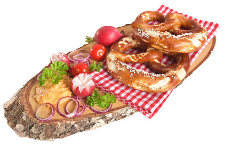 Bavarian vegetarian breakfast with two soft pretzels and cheese delicacy from Germany isolated on whiteの写真素材