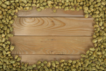 many dried hops on old weathered wooden boardの写真素材