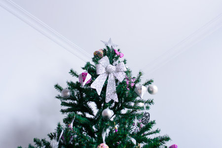 Christmas tree close-up and its ornaments on white background.の写真素材