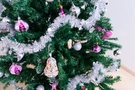 Christmas tree close-up and its ornaments on white background.